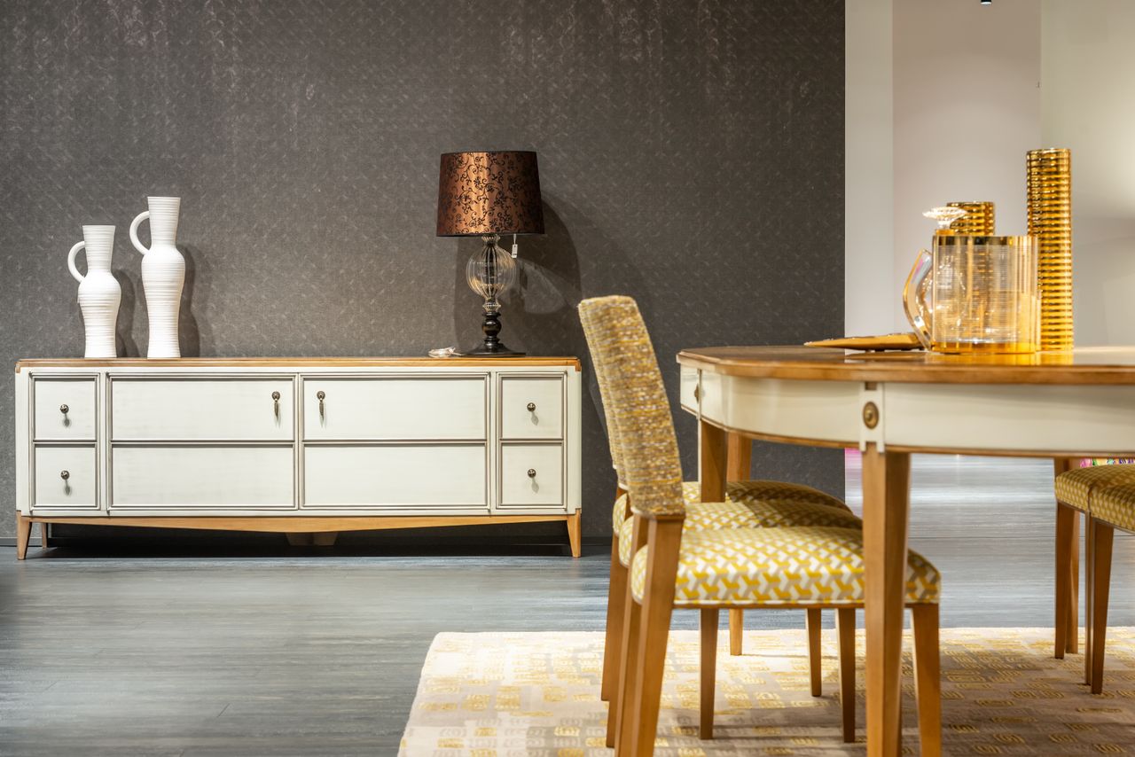 Interior of cozy dining room in classic design with wooden table and chairs